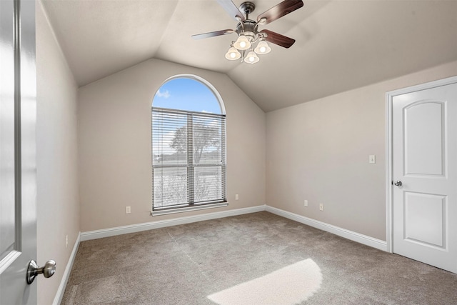 additional living space featuring baseboards, carpet flooring, a ceiling fan, and lofted ceiling