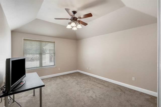 unfurnished office featuring baseboards, lofted ceiling, ceiling fan, and carpet flooring