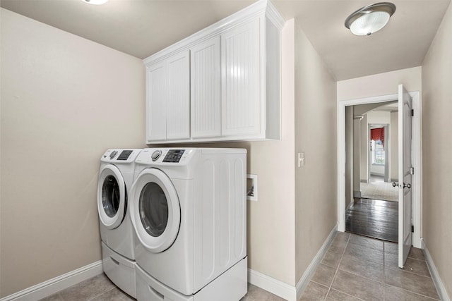 2118 Darby Dan Ct, Granbury, TX 76049 - laundry area with washer and dryer, baseboards, cabinet space, and light tile patterned floors