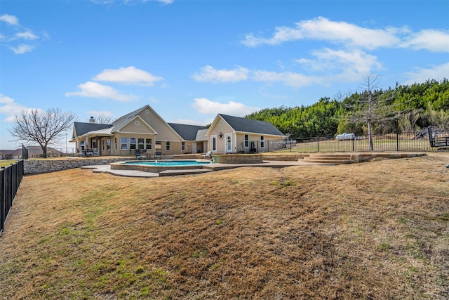 view of yard featuring a patio area, a garden, fence, and a fenced in pool