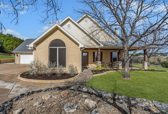 view of front of house featuring a front lawn, a porch, concrete driveway, a garage, and brick siding