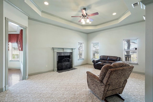 living room featuring visible vents, crown molding, and a raised ceiling