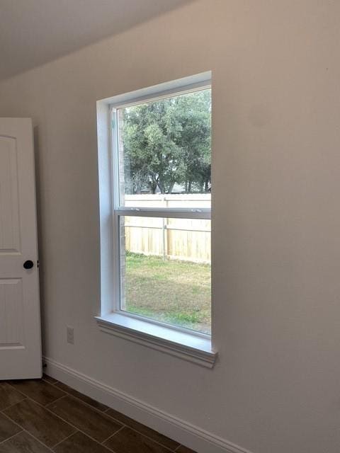 spare room featuring baseboards