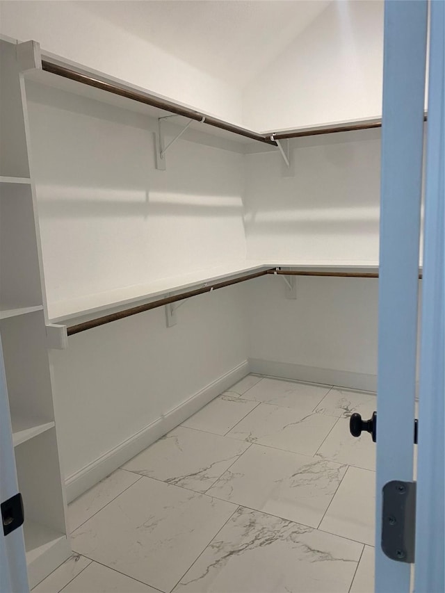 spacious closet with marble finish floor