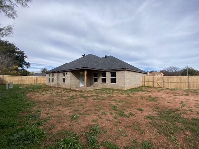 rear view of house featuring a patio area and a fenced backyard