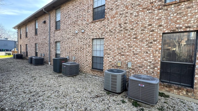 view of home's exterior featuring central AC and brick siding