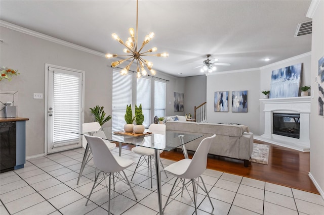 1503 Norway Pine St, Arlington, TX 76012 - dining room with plenty of natural light, light tile patterned floors, a chandelier, crown molding, and a glass covered fireplace