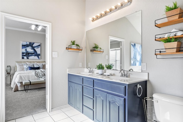 1503 Norway Pine St, Arlington, TX 76012 - full bath featuring tile patterned floors, connected bathroom, double vanity, toilet, and a ceiling fan