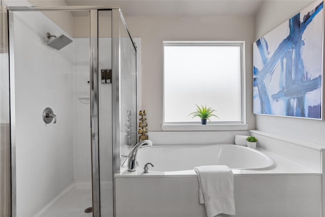 bathroom featuring a bath and a shower stall