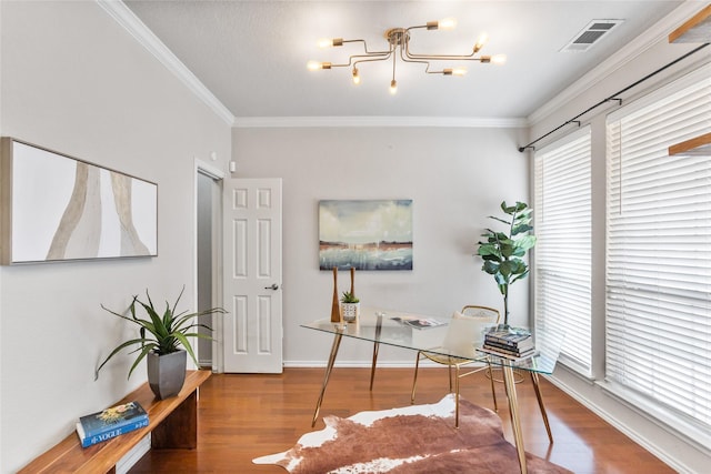 office space featuring visible vents, baseboards, a chandelier, ornamental molding, and wood finished floors