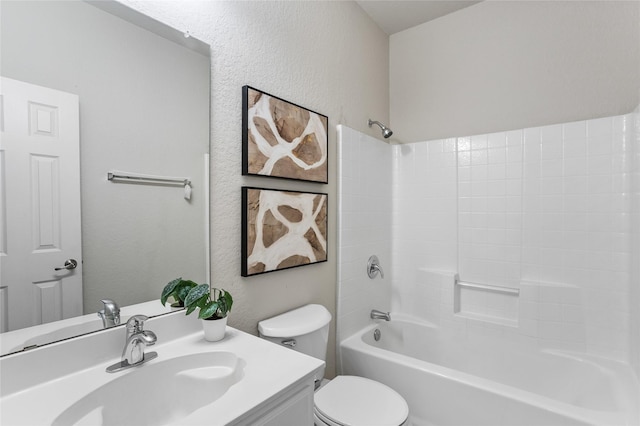 bathroom featuring tub / shower combination, toilet, vanity, and a textured wall