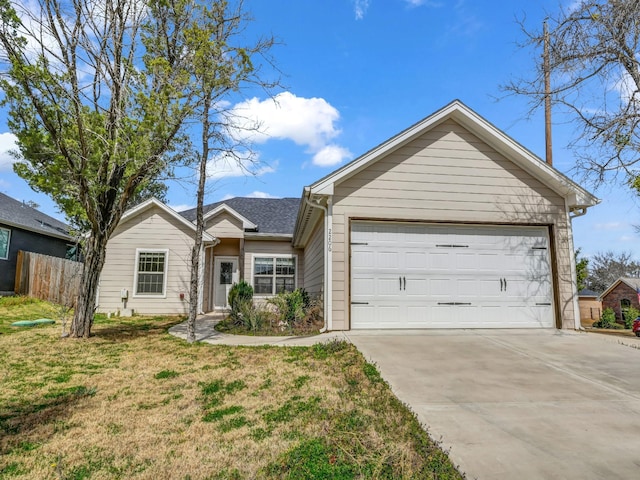 ranch-style home featuring a front lawn, concrete driveway, fence, and an attached garage