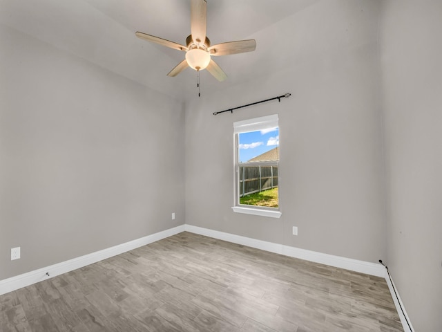 unfurnished room with a ceiling fan, baseboards, and wood finished floors