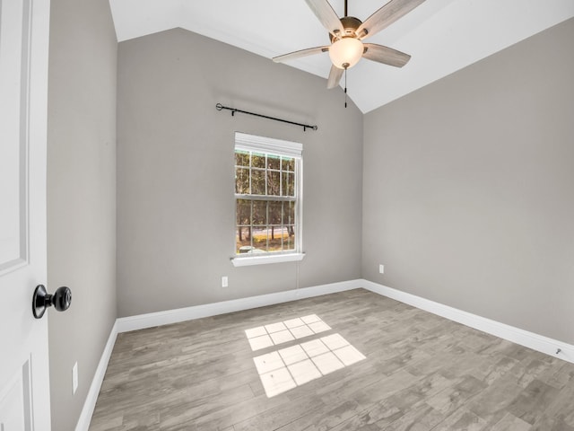 empty room featuring lofted ceiling and wood finished floors