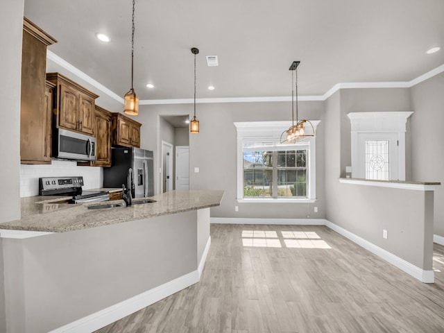 kitchen featuring decorative backsplash, appliances with stainless steel finishes, light wood-type flooring, a peninsula, and baseboards