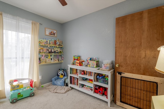 recreation room with carpet flooring and a ceiling fan