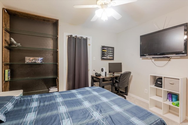 carpeted bedroom featuring a ceiling fan and baseboards