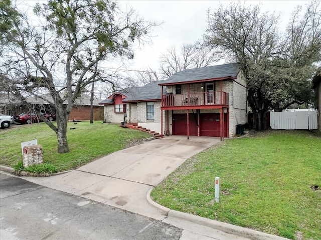 view of front facade with an attached garage, brick siding, fence, concrete driveway, and a front yard