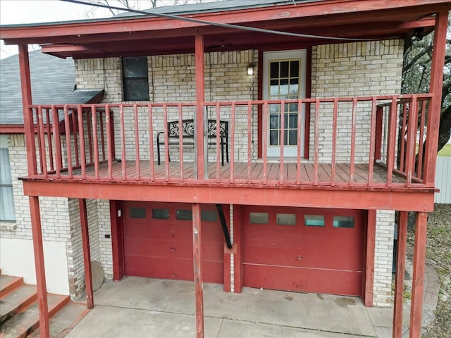 exterior space featuring a garage and brick siding