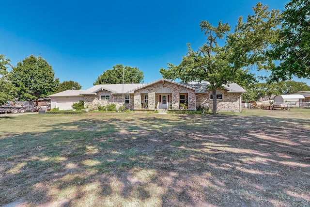 ranch-style home featuring stone siding and a front yard