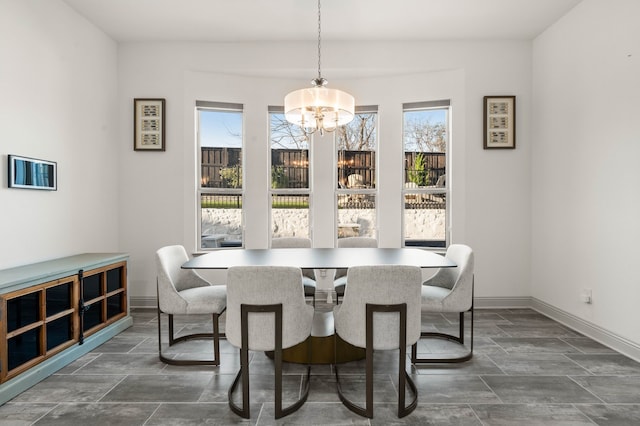 dining room with baseboards and an inviting chandelier