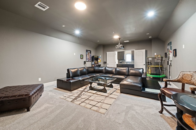 carpeted living area featuring baseboards, visible vents, and recessed lighting