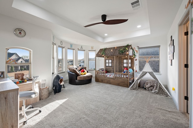 interior space with baseboards, visible vents, a raised ceiling, and recessed lighting