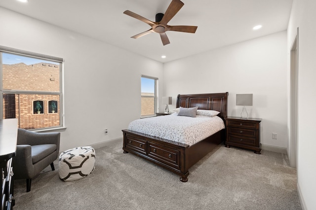 bedroom with baseboards, recessed lighting, and light colored carpet