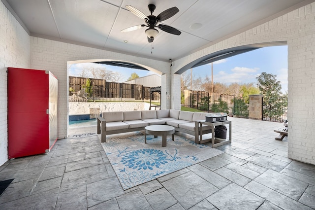 view of patio / terrace with a fenced backyard, an outdoor living space, and a ceiling fan