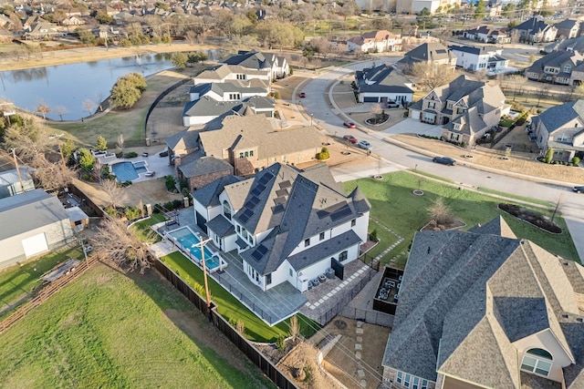 birds eye view of property with a water view and a residential view