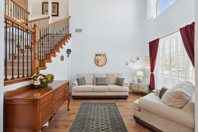 3532 Delaney Dr, Fort Worth, TX 76244 - living room featuring a towering ceiling, light wood-style floors, and stairs