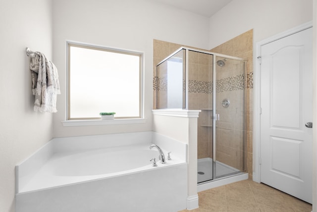 full bathroom with a shower stall, a bath, and tile patterned floors