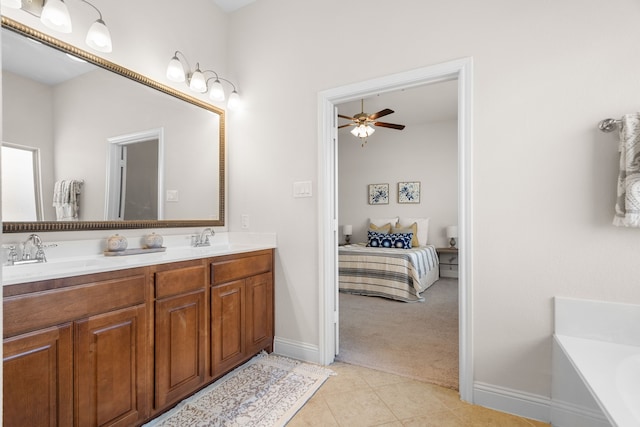 ensuite bathroom with connected bathroom, a sink, a tub, and tile patterned floors