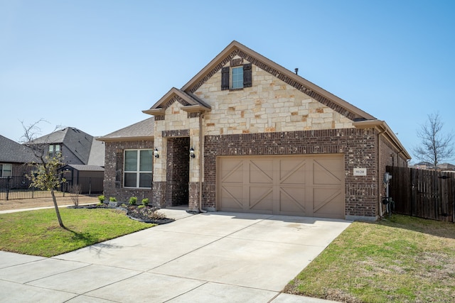 view of front of home with a garage, brick siding, fence, concrete driveway, and a front lawn