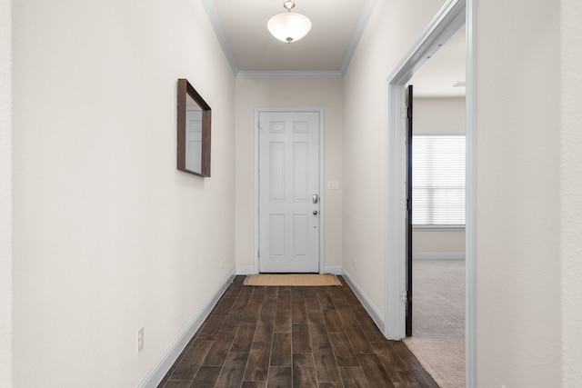 hall with ornamental molding, baseboards, and dark wood-style floors