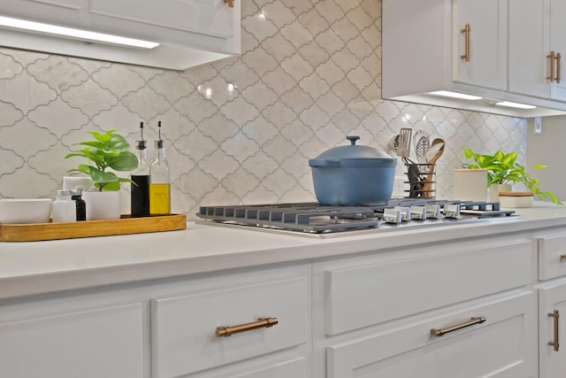 kitchen featuring light countertops, white cabinetry, and decorative backsplash