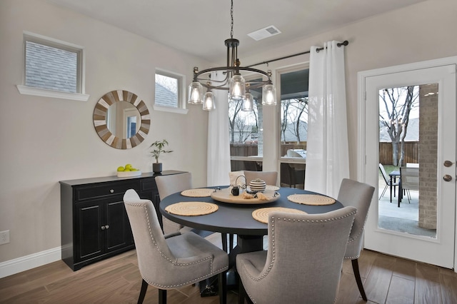 dining space with visible vents, baseboards, and wood finished floors