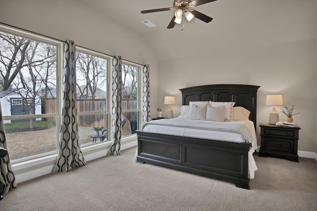 bedroom with visible vents, light carpet, vaulted ceiling, ceiling fan, and baseboards