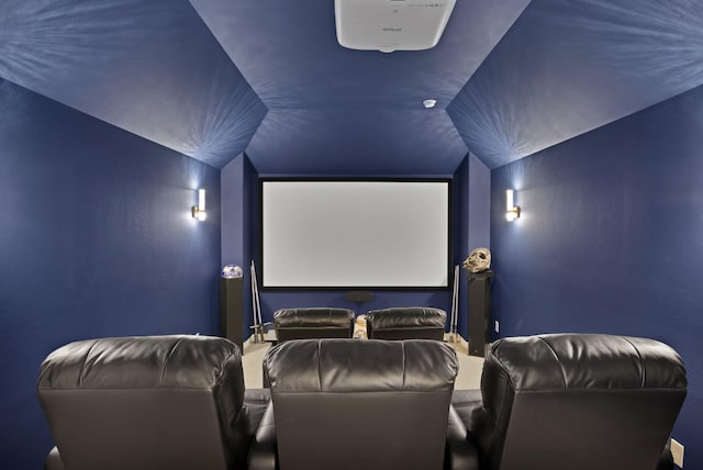 cinema room featuring vaulted ceiling