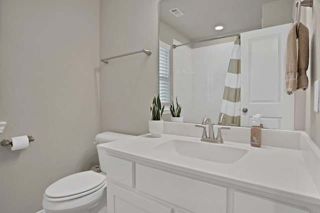 bathroom featuring toilet, visible vents, a shower with shower curtain, and vanity