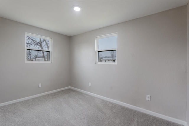 carpeted spare room with baseboards