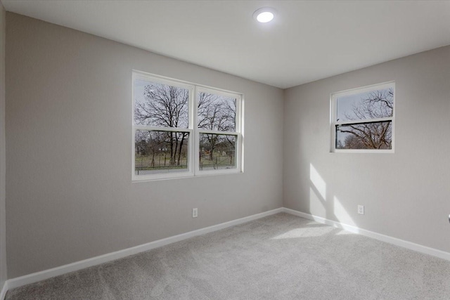 carpeted spare room with baseboards