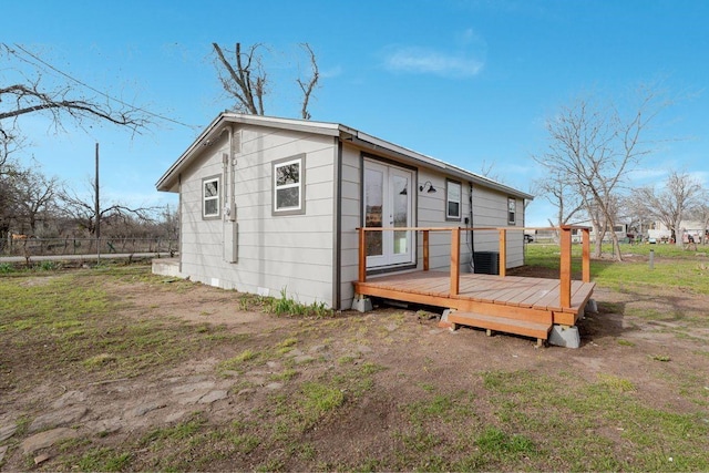 back of house with fence and a wooden deck