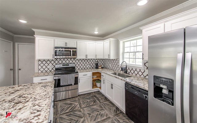 kitchen with light stone counters, appliances with stainless steel finishes, ornamental molding, white cabinetry, and a sink