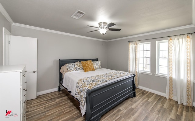 bedroom featuring baseboards, visible vents, and wood finished floors