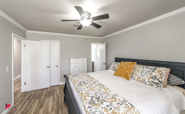 bedroom featuring visible vents, dark wood finished floors, a ceiling fan, ornamental molding, and a closet