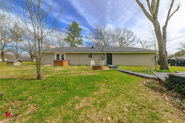 view of front of home with brick siding and a front yard