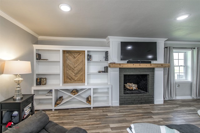 living room featuring ornamental molding, recessed lighting, a brick fireplace, and wood finished floors