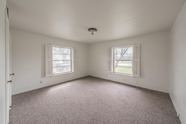 spare room with carpet and baseboards