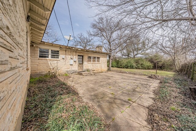 exterior space with a chimney, a patio area, and fence